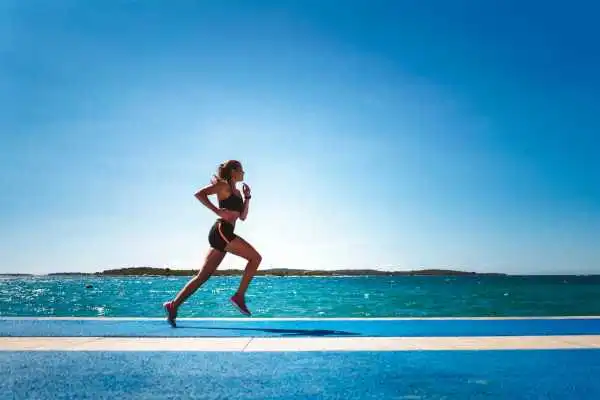 Woman running showing strong leg muscle Ayr